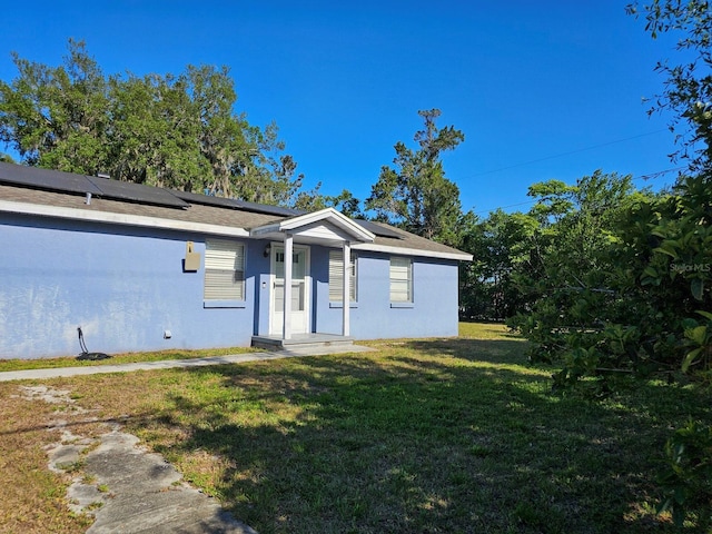 15 Estrella Rd, Debary, FL 32713 - single story home with a front lawn, stucco siding, and solar panels