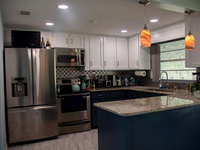 15 Estrella Rd, Debary, FL 32713 - kitchen featuring stainless steel appliances, a sink, a peninsula, white cabinetry, and light stone countertops