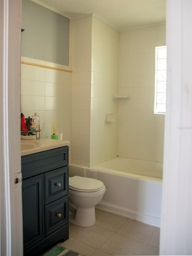 15 Estrella Rd, Debary, FL 32713 - bathroom with tile walls, toilet, tile patterned flooring, vanity, and a textured ceiling