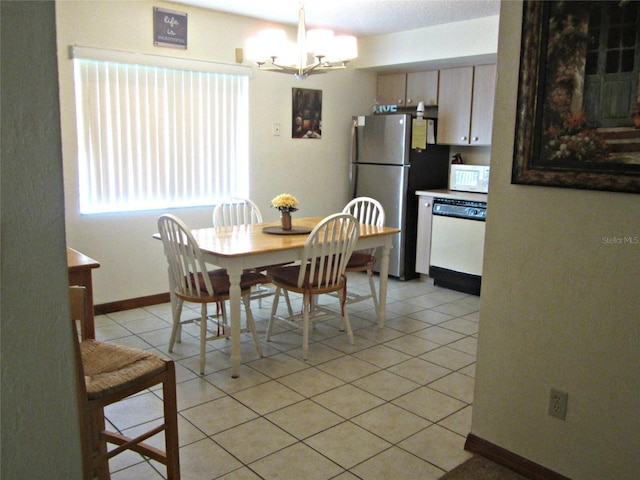 2073 Oak Meadow Cir S, Daytona, FL 32119 - dining room with baseboards, an inviting chandelier, and light tile patterned floors