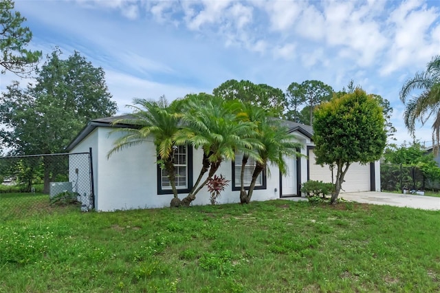 969 Commerce Rd SE, Palm Bay, FL 32909 - view of front of home featuring stucco siding, concrete driveway, and an attached garage