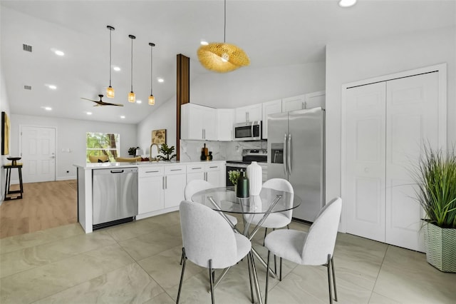 969 Commerce Rd SE, Palm Bay, FL 32909 - dining area with a ceiling fan, high vaulted ceiling, and recessed lighting