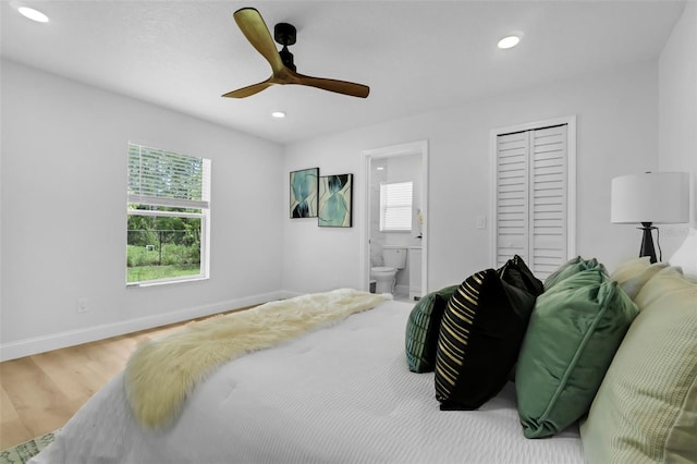 969 Commerce Rd SE, Palm Bay, FL 32909 - bedroom featuring multiple windows, a closet, wood finished floors, recessed lighting, and ensuite bath