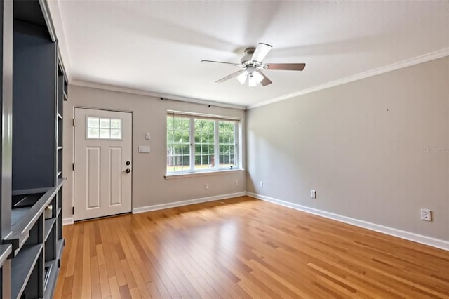 foyer with baseboards, ornamental molding, a ceiling fan, and light wood-style flooring