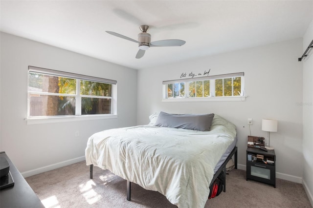bedroom with baseboards, carpet floors, and multiple windows