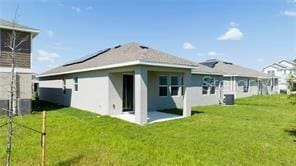 1163 James Paul Rd, Davenport, FL 33837 - back of house with a yard and stucco siding
