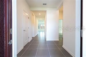 1163 James Paul Rd, Davenport, FL 33837 - hallway with baseboards and dark tile patterned flooring