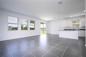 1163 James Paul Rd, Davenport, FL 33837 - unfurnished living room with recessed lighting and dark tile patterned floors
