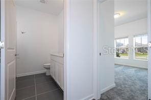 1163 James Paul Rd, Davenport, FL 33837 - bathroom with vanity, toilet, and baseboards