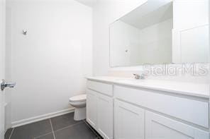 1163 James Paul Rd, Davenport, FL 33837 - full bath featuring vanity, toilet, tile patterned floors, and baseboards