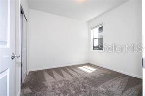1163 James Paul Rd, Davenport, FL 33837 - unfurnished bedroom featuring carpet floors and baseboards