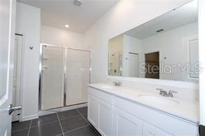 1163 James Paul Rd, Davenport, FL 33837 - full bath featuring double vanity, tile patterned flooring, and a shower stall