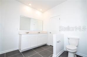 1163 James Paul Rd, Davenport, FL 33837 - bathroom with toilet, vanity, and tile patterned flooring