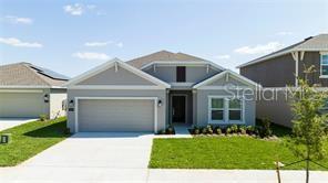 1163 James Paul Rd, Davenport, FL 33837 - view of front of property featuring an attached garage, driveway, and a front yard