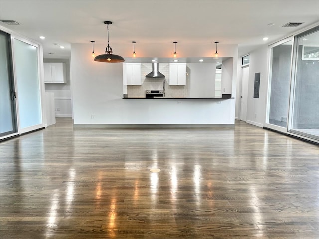 unfurnished living room featuring baseboards, dark wood-style flooring, electric panel, and visible vents