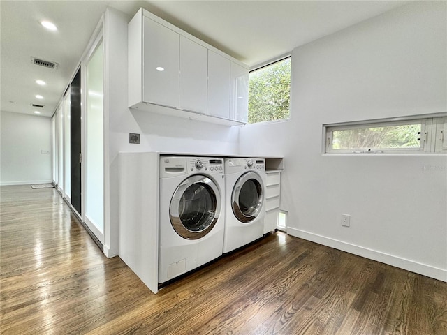 laundry room with separate washer and dryer, baseboards, wood finished floors, and visible vents