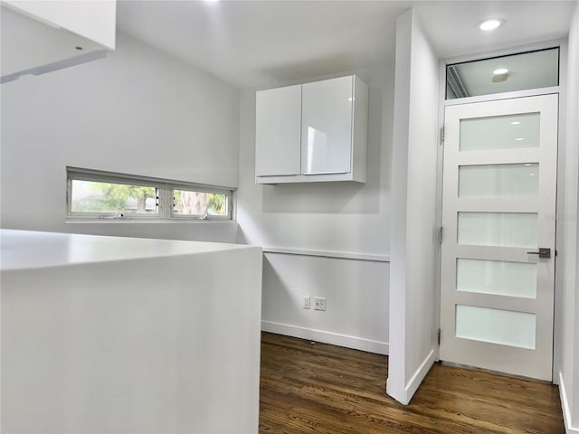 interior space with baseboards, wood finished floors, and recessed lighting