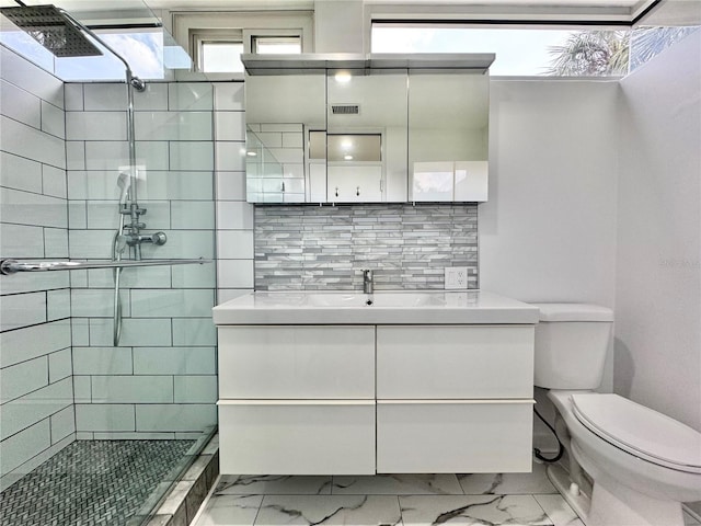 full bathroom featuring toilet, a stall shower, decorative backsplash, marble finish floor, and vanity