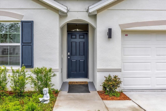 entrance to property featuring stucco siding