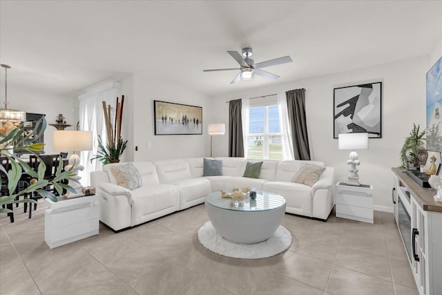 living area featuring light tile patterned flooring and ceiling fan