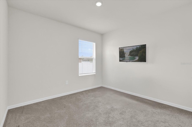 empty room with recessed lighting, baseboards, and carpet