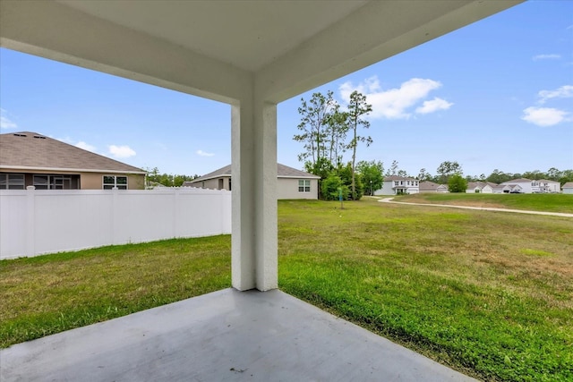 view of patio featuring fence and a residential view