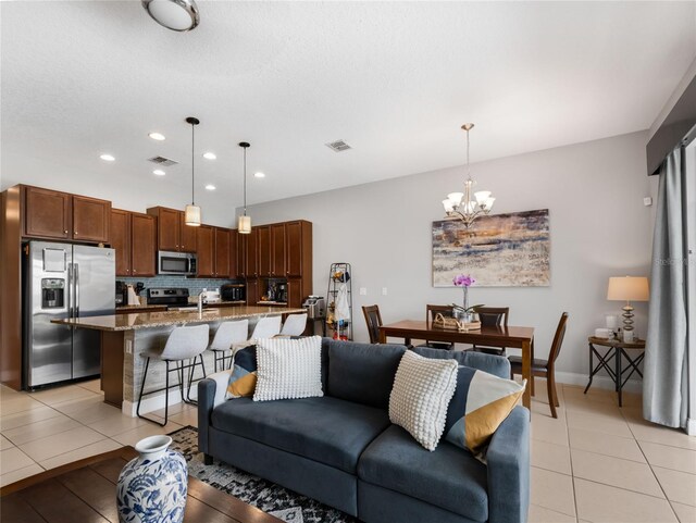193 Captiva Dr, Davenport, FL 33896 - living area with an inviting chandelier, light tile patterned floors, recessed lighting, and visible vents