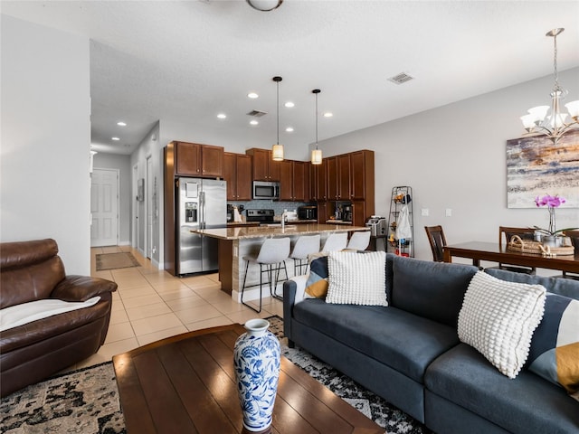 193 Captiva Dr, Davenport, FL 33896 - living room featuring recessed lighting, visible vents, an inviting chandelier, and light tile patterned floors