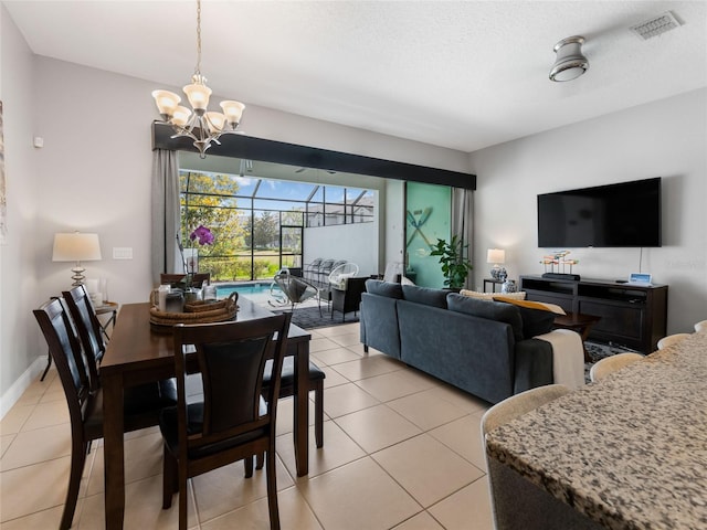 193 Captiva Dr, Davenport, FL 33896 - dining area featuring visible vents, a notable chandelier, a sunroom, and light tile patterned flooring