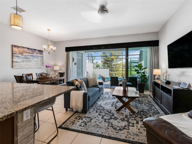 193 Captiva Dr, Davenport, FL 33896 - living area featuring visible vents, a textured ceiling, light tile patterned floors, and a chandelier