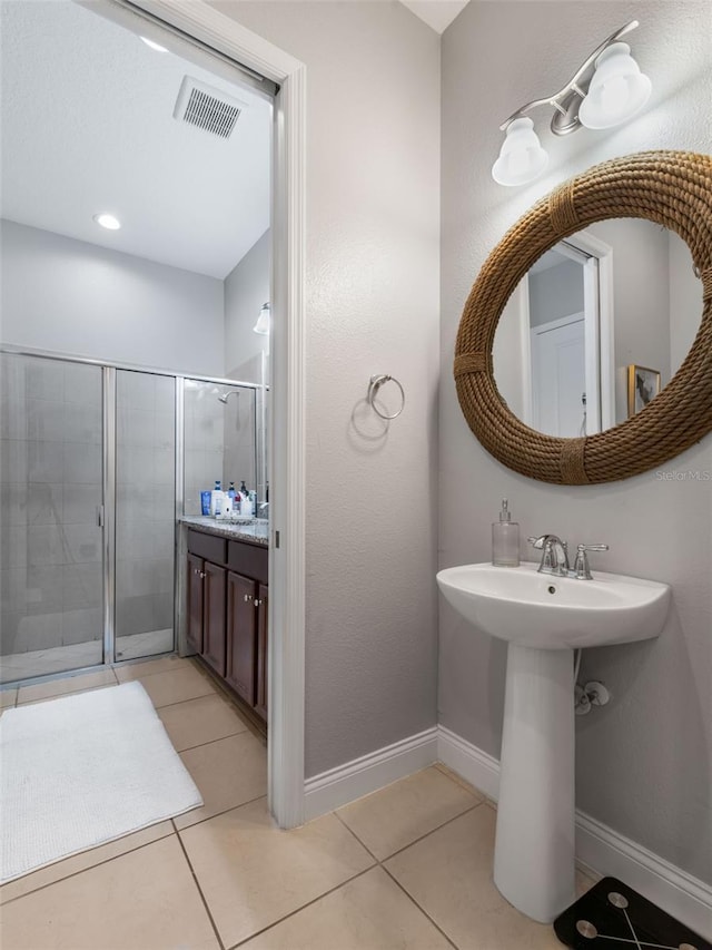 193 Captiva Dr, Davenport, FL 33896 - full bathroom featuring tile patterned floors, baseboards, a shower stall, and visible vents