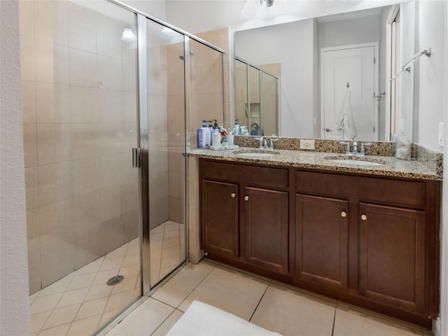 193 Captiva Dr, Davenport, FL 33896 - full bathroom with double vanity, a sink, tile patterned floors, and a shower stall