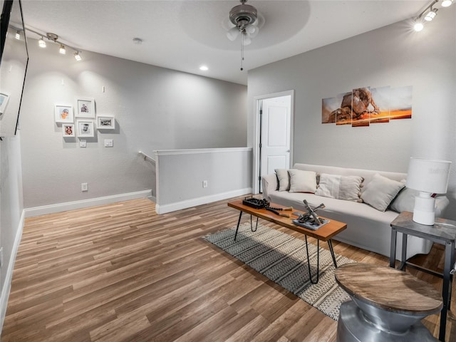 193 Captiva Dr, Davenport, FL 33896 - living room with a ceiling fan, baseboards, wood finished floors, and rail lighting