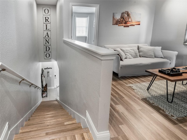 193 Captiva Dr, Davenport, FL 33896 - stairway with baseboards, a textured wall, and wood finished floors