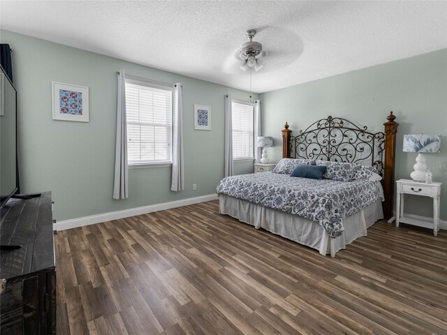 193 Captiva Dr, Davenport, FL 33896 - bedroom with dark wood-style flooring, a textured ceiling, ceiling fan, and baseboards
