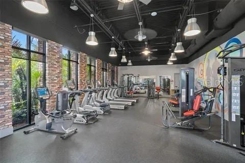 193 Captiva Dr, Davenport, FL 33896 - exercise room featuring brick wall