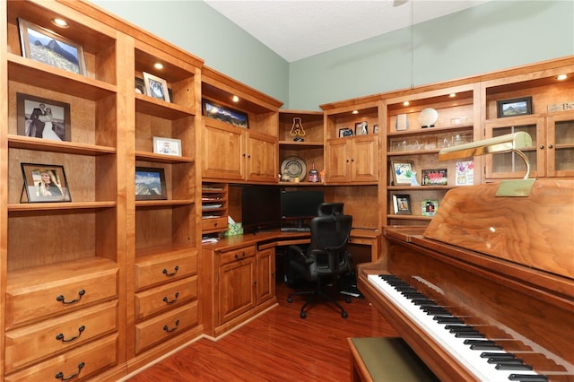 office space featuring built in desk and dark wood-type flooring