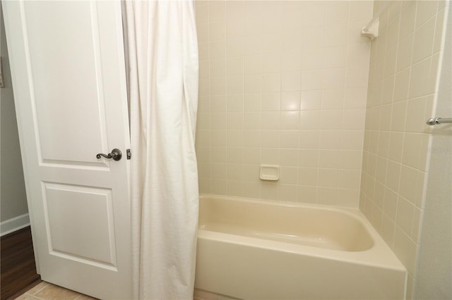 bathroom featuring shower / bathtub combination with curtain
