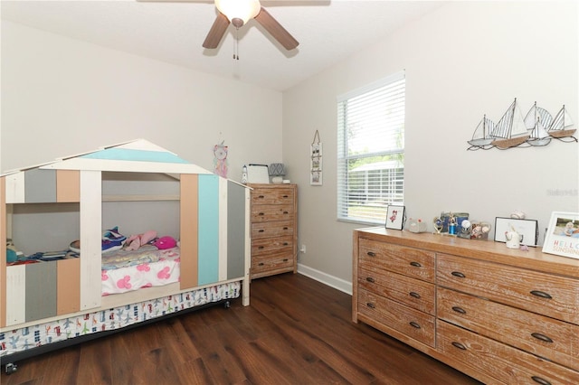 bedroom with dark wood-type flooring, ceiling fan, and baseboards