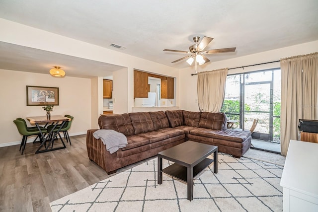 150 Waterfall Way Unit 102, Altamonte Springs, FL 32714 - living area with baseboards, visible vents, ceiling fan, and light wood-style flooring