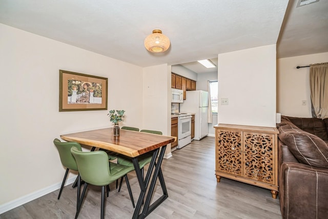 150 Waterfall Way Unit 102, Altamonte Springs, FL 32714 - dining space with light wood-style flooring and baseboards
