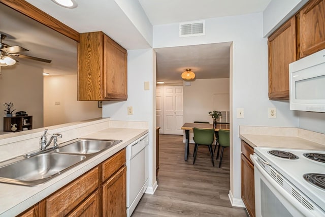 150 Waterfall Way Unit 102, Altamonte Springs, FL 32714 - kitchen with brown cabinets, visible vents, white appliances, and a sink