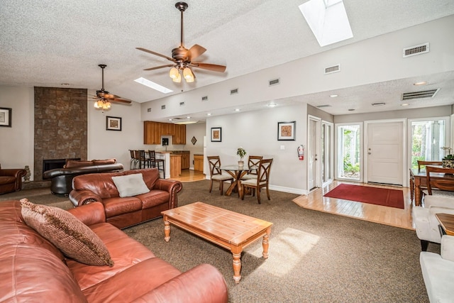 150 Waterfall Way Unit 102, Altamonte Springs, FL 32714 - living area featuring lofted ceiling with skylight, a ceiling fan, visible vents, and a textured ceiling