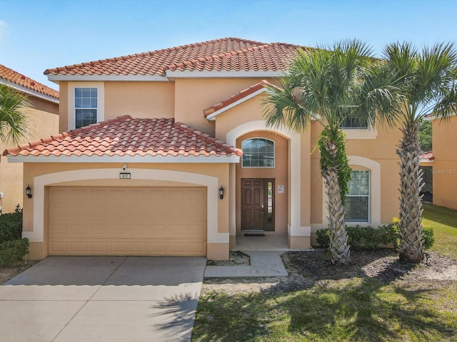 411 Cabello Dr, Davenport, FL 33837 - mediterranean / spanish-style house featuring a tiled roof, an attached garage, driveway, and stucco siding