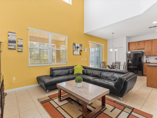 411 Cabello Dr, Davenport, FL 33837 - living area featuring baseboards, a high ceiling, light tile patterned flooring, and visible vents