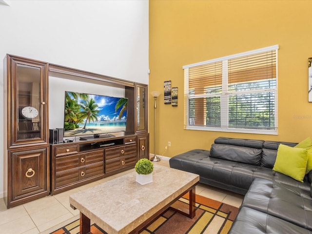 411 Cabello Dr, Davenport, FL 33837 - living room with light tile patterned floors, baseboards, and a high ceiling