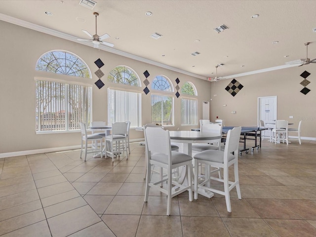 411 Cabello Dr, Davenport, FL 33837 - tiled dining space featuring visible vents, a ceiling fan, plenty of natural light, and ornamental molding