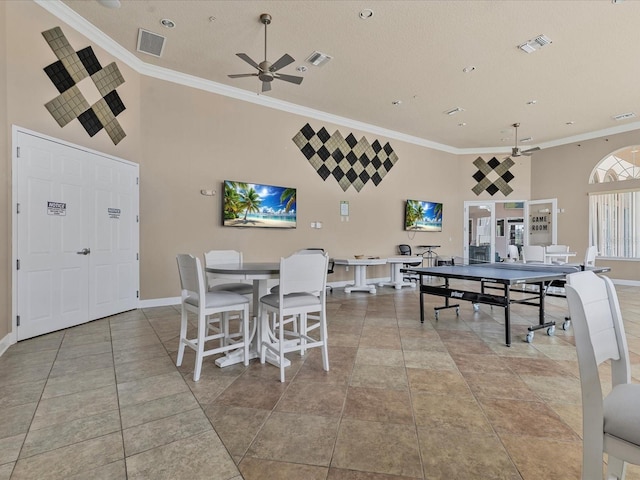 411 Cabello Dr, Davenport, FL 33837 - dining area featuring crown molding, ceiling fan, visible vents, and a towering ceiling