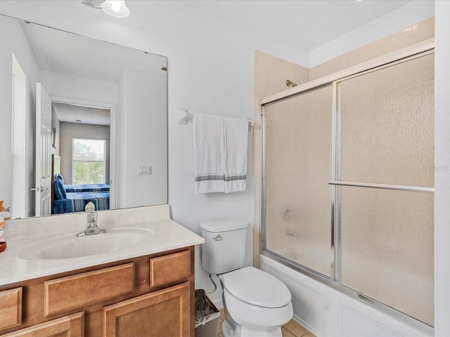 411 Cabello Dr, Davenport, FL 33837 - bathroom with vanity, bath / shower combo with glass door, and toilet