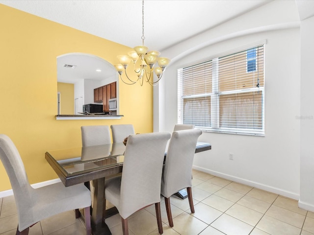411 Cabello Dr, Davenport, FL 33837 - dining area with an inviting chandelier, arched walkways, baseboards, and visible vents